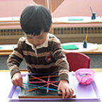 Little boy playing on the table with elastic